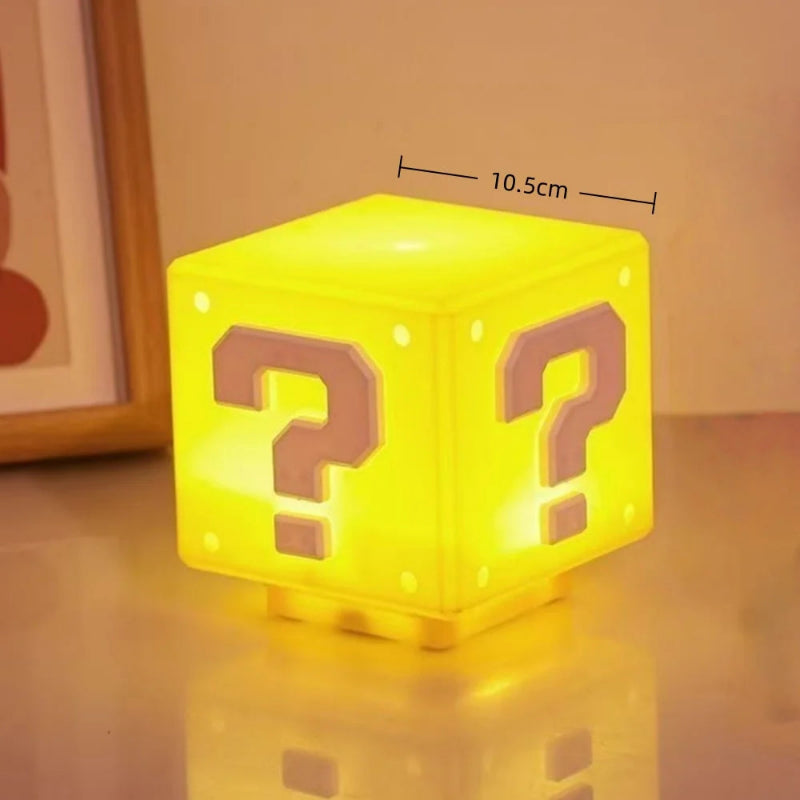 3D LED question mark brick lamp glowing yellow, 4.1in cube size shown on desk